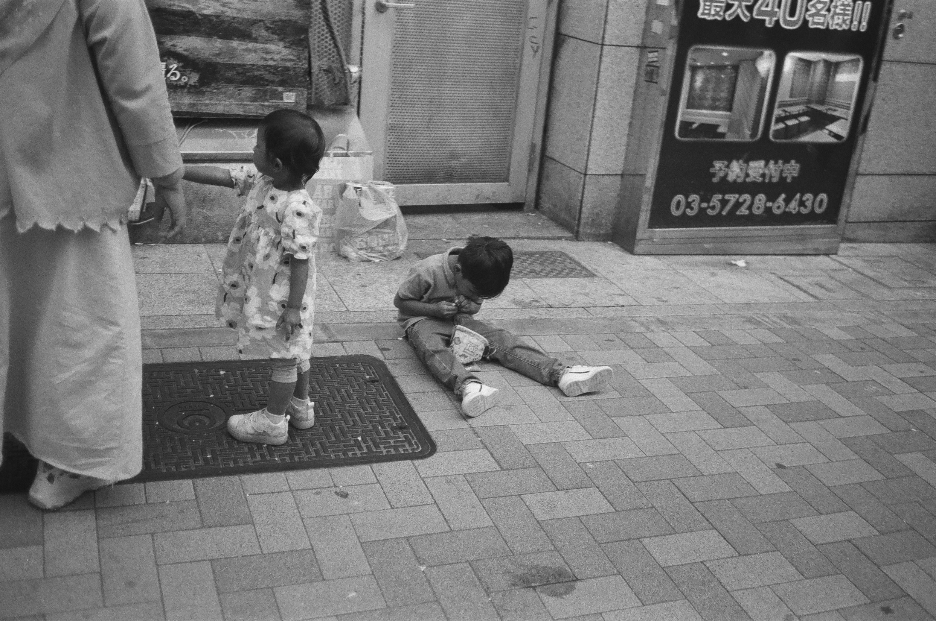 child sitting on the floor unboxing a toy